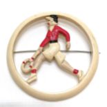 Large early plastics tennis player brooch (7.5cm diameter)