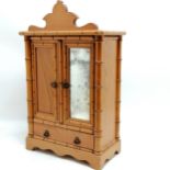 Antique table cabinet in the form of a 2 door cabinet with drawer to base with faux bamboo