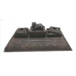 Antique carved ebony desk stand with original inkwells and covers and an elephant on the central