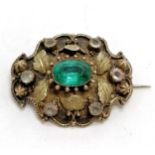 Georgian locket back gilt metal brooch with green paste centre surrounded by rock crystal stones -