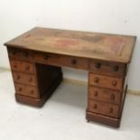 Antique mahogany pedestal desk with china castors and red leather insert to top 107cm long x 67cm