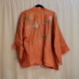 Chinese coral coloured silk jacket embroidered front and back in good condition