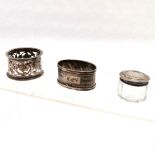 2 x sterling silver napkin rings (pierced has rubbed marks) t/w small glass silver lidded pot (dents