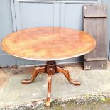 An Antique mahogany circular dining table on pedestal base with 4 cabriole legs terminating on pad