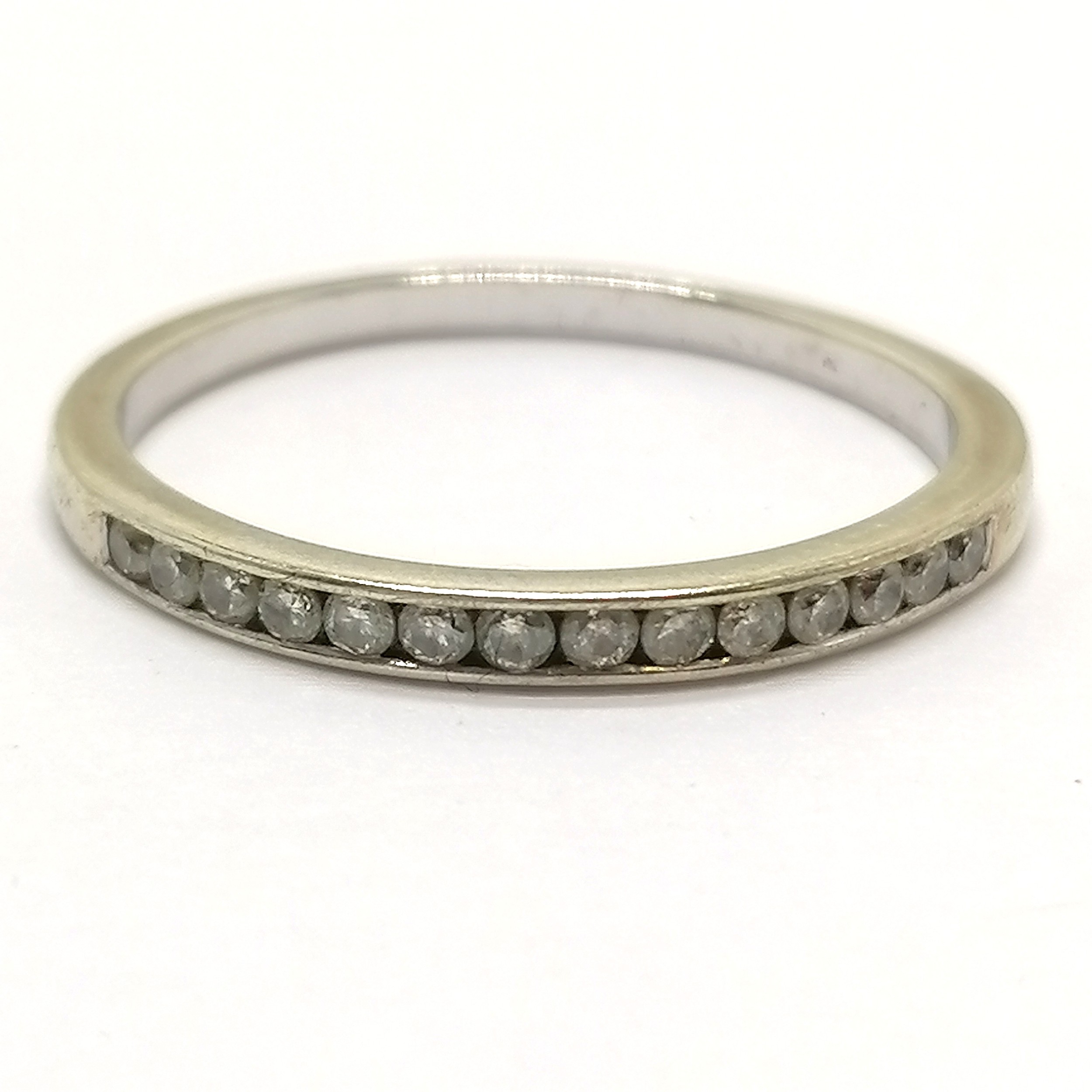 Unmarked white gold half eternity ring channel set with 14 diamonds - size S & 2g total weight