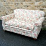 2 seater sofa with bun feet. In good used condition - 142cm long x 80cm high x 89cm deep