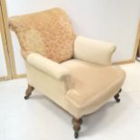 Edwardian oak framed upholstered easy chair on turned legs ending in castors, 82 cm in height, 78 cm