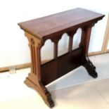 An Ecclesiastical influenced carved side table, with triple arch decorated support, 76 cm in height,