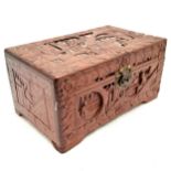 An oriental carved camphorwood box decorated with various carved scenes, complete with lock and key,