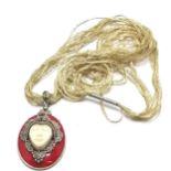 Silver red grounded pendant with carved mask detail & set with garnet / peridot - 5.5cm drop & is on