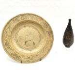 Oriental brass plate decorated with dragons, seal mark to reverse 28 cm in diameter t/w a pipe.