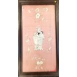 Oak framed Oriental embroidered silk panel of a family scene within floral border, slightly faded,