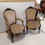 Pair of antique open arm salon chairs with carved detail on casters. 100 x 60 x 58cm.