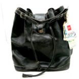 Black Leather travel bag 54 cm wide, 44 cm high with an interesting collection of baggage tags, to