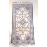 Wool rug with central medallion decoration, slight staining, 69 cm wide, 140 cm length.