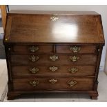 Georgian walnut bureau on ogee bracket feet with fitted interior with leather book detailing to