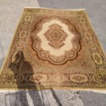 Large rug cream and green 430cm x 300cm- has some losses to the fringe and a tear along 1 edge