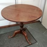 Antique mahogany tip top occasional table on turned centre column terminating on tripod base,