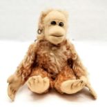 Antique mohair monkey, with googly-eyes, play worn condition, worn feet and hand pads, 32 cm high,