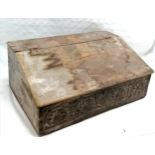 Antique bible box with carved panel front & 2 drawers to interior & old ironwork hinges to sloping