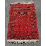 Afghanistan prayer rug in red. Measures 115 x 78cm. In used condition with slight fading.