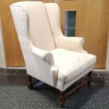 Antique cream upholstered wing armchair with feather seat cushion 100cm high x 76cm x 76cm