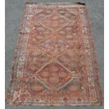 Qashqai Persian rug ca1900 in red and cream. Measures 217 x 137cm. In used condition with obvious