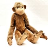 Antique brown mohair monkey, play worn condition, pads and hands very worn, hole to face,72 cm