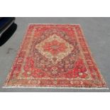 Bakhtiari red grounded wool rug with red and cream central medallion 200 x 295cm