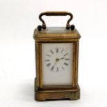 Antique miniature carriage clock with a gilt brass case has key and runs total height 9cm