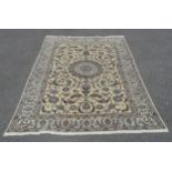 Meshed cream grounded wool rug with circular medallion and blue floral decoration 192 x 292cm