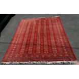 Large Pakistani Bokhara late 20th century carpet in red. Measures 302 x 225cm. In good used