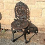 Cast iron garden chair with a figure to the back panel