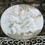 Oval wall plaque depicting cherubs with a garland 66cm x 56cm- some losses to the paint finish