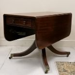 Antique mahogany drop flap tea table, on turned column on 4 splayed legs terminating brass