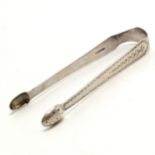 Sterling silver pair of bright cut sugar tongs with good detail by CT - 14cm & 41g & crest detail to