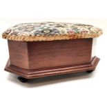 Upholstered mahogany footstool with ceramic feet. Reupholstered top which lifts up. Measures 35 x 30