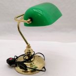 Brass bankers lamp with a green glass shade. Measures 35cm high.