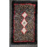 Antique small rag rug, black and red with three diamonds to the centre, 145cm x 83cm, in overall