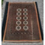 Rust ground with all over geometric pattern rug, 126 cm wide, 180 cm, some signs of wear to 1 side.