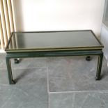 An oriental green painted glass top coffee table with gilded highlights, 92 cm length, 40 cm high,