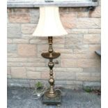 Indian embossed brass floor lamp, on heavy granite base,1 corner a/f and added wooden bun feet,