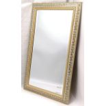 Contemporary wood framed mirror with vine leaf detail and bevelled mirror plate. Measures 87 x 52cm.