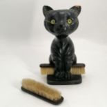 Antique ebonised carved wooden brush stand in the form of a cat with green glass eyes - 28cm