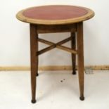 Heals inspired circular oak table, with brown leather inset top, on cross supports, square tapered