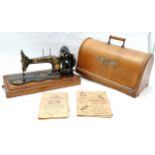 Vintage cased Singer sewing machine, The Family Machine, with some original paperwork.