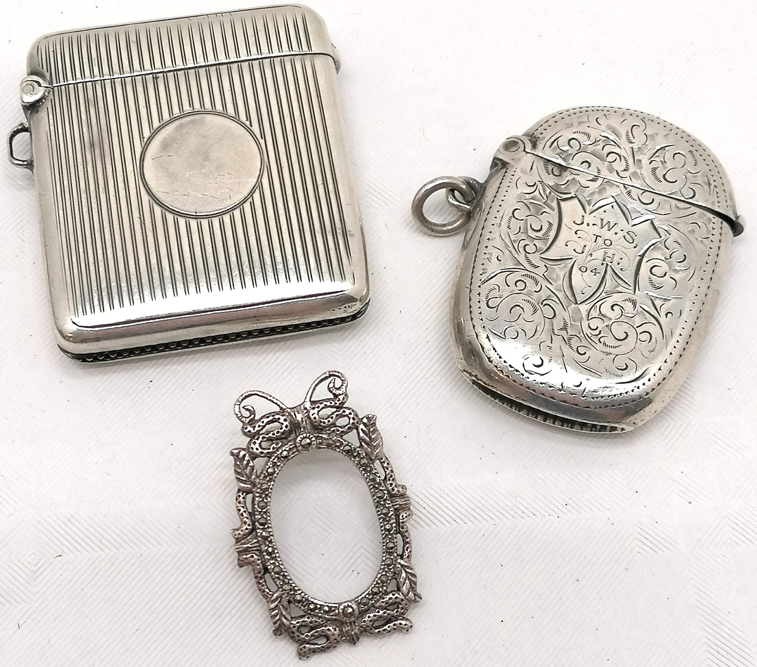 2 x silver vestas (largest 4.8cm x 4.2cm) - both have slight dents t/w silver miniature frame set