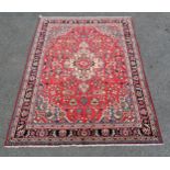 Hamadan red grounded rug with central medallion depicting a flower. Measures 200cm x 138cm. Very