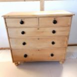 Antique pine chest of 3 short and 3 long graduated drawers with black ceramic knobs, on replaced bun