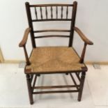 Antique elm rush seated elbow chair, with spindle back rail, on turned legs, 53 cm wide, 83 cm high,